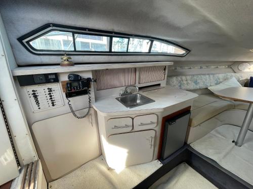 a small kitchen with a sink and a refrigerator at Yate Eos in Badalona