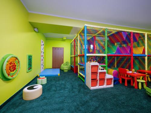 a childrens play room with colorful play equipment at Hotel Liptakówka in Białka Tatrzanska