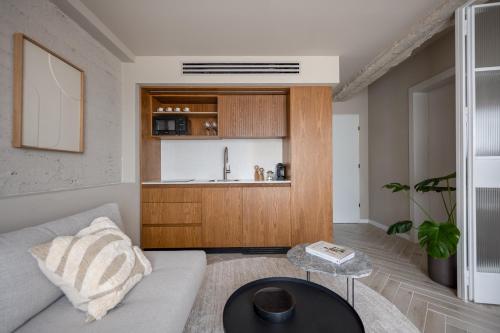 a living room with a couch and a table at GoodHouse 404 - Beautiful 1 Bdr near Ben Yehuda Street in Jerusalem