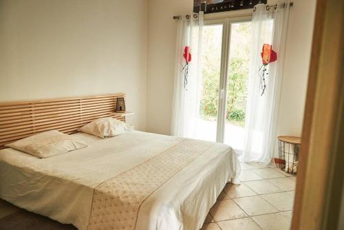 une chambre avec un lit et une grande fenêtre dans l'établissement Le gîte de Fontsainte, à La Ciotat