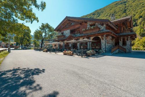 a large log building on the side of a road at B&B San Sebastiano in Vernante