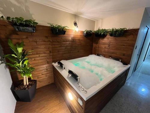 een bad met planten op een houten muur bij Descanso y Confort in Medellín