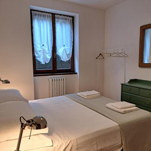 a bedroom with a large bed and a window at La casa di Guia in Perledo