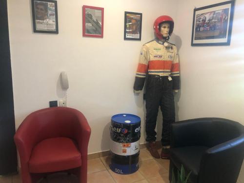a man wearing a helmet standing in a room at Enzo Hotels Chartres Mainvilliers by Kyriad Direct in Chartres