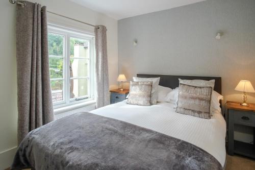 a bedroom with a large bed and a window at White Hart Inn in Ironbridge