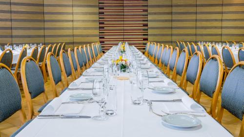 a long long table in a room with chairs at Hotel Unione in Bellinzona