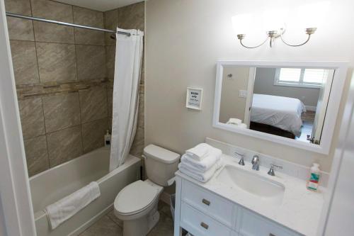 a bathroom with a sink and a toilet and a shower at New Construction - Pristine Home - Great Location in Stuart