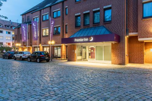 a brick building with a parking lot in front of it at Premier Inn Braunschweig City Centre in Braunschweig