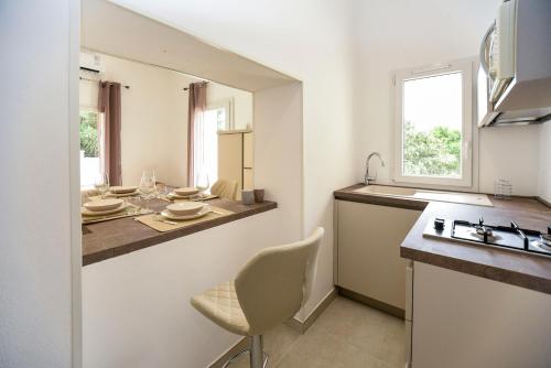 a kitchen with a sink and a counter top at Zeituna Lodge a Porto Cesareo in Torre Lapillo