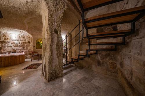 a hallway with a staircase in a stone building at Janus Cappadocia in Nevsehir