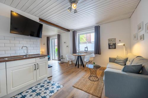 a living room with a couch and a table at Boutique 54° Nord in Büsum