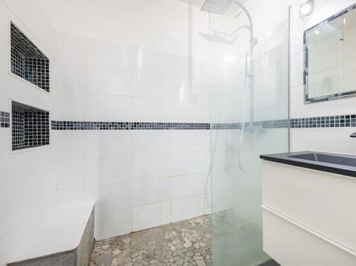 a white bathroom with a shower and a sink at Mer d'Elen VII in Marseille