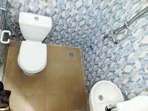 a bathroom with a toilet and a sink at RÉSIDENCE NGUARY in Dakar