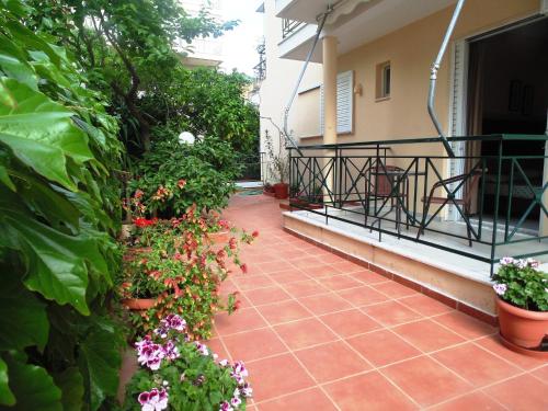a balcony with a bunch of flowers and plants at Nefeli Studios in Loutra Edipsou