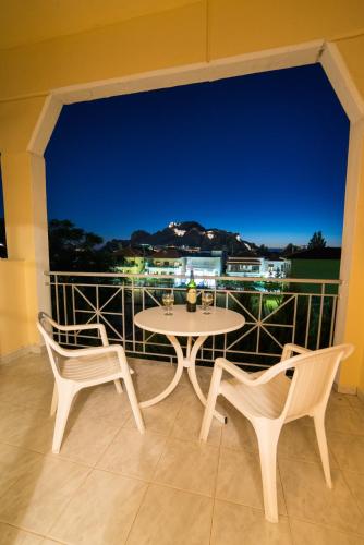 a table and two chairs on a balcony with a view at Hotel Diamantidis in Mirina