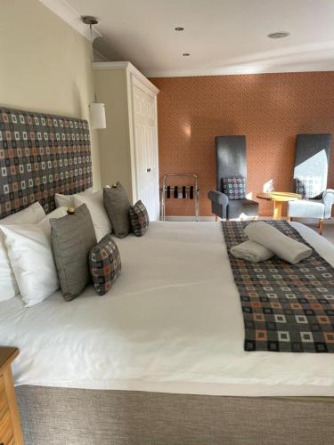 a large white bed in a room with at Roseberry House in Newcastle Emlyn