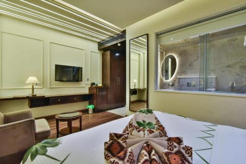a hotel room with a bed and a large window at HOTEL BR INTERNATIONAL in Amritsar