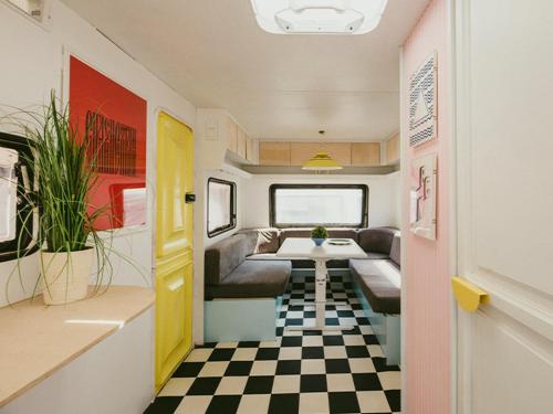 an rv with a black and white checkered floor at Bueno Campers - lux przyczepy na wynajem in Jastarnia