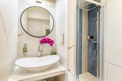 a bathroom with a sink and a mirror at Luxury 2 Bedroom Eiffel-Tower with Terrace in Paris