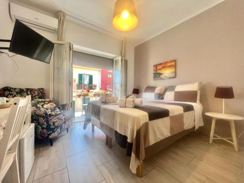 a hotel room with a bed and a television at A Casa dei Bruno B&B in Pozzuoli