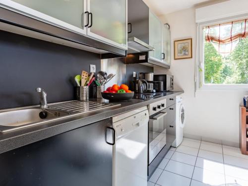 a kitchen with stainless steel appliances and a sink at Apartment Elisa-1 by Interhome in Trouville-sur-Mer