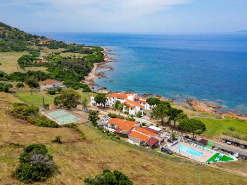 - une vue aérienne sur une maison et l'océan dans l'établissement Apartment Punta Paliagi - TUC160 by Interhome, à Calcatoggio