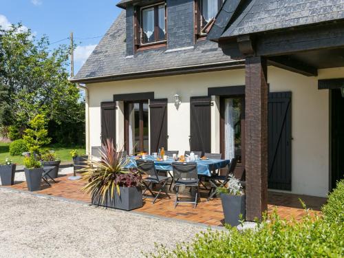 a patio with a blue table and chairs at Holiday Home Villa Rocuet by Interhome in Trégunc