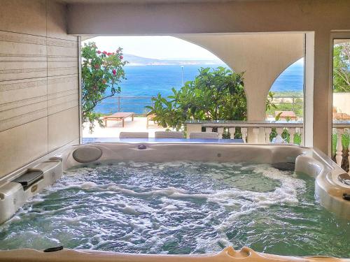 a jacuzzi tub with a view of the ocean at Holiday Home Stana by Interhome in Klenovica