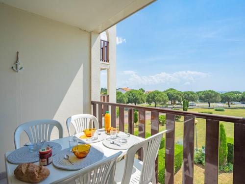 a table and chairs on a balcony with a view at Apartment Les Balcons de l'Atlantique-10 by Interhome in Pontaillac