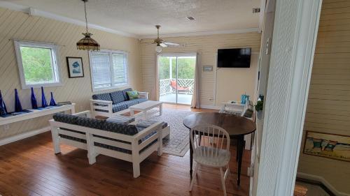 a living room with a couch and a table at 114 Sandbar, Private Pool, Short Walk to Beach in Duck