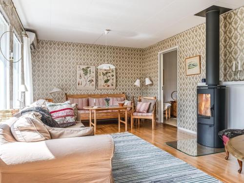 a living room with a couch and a fireplace at Holiday Home Mölltorp - VGT119 by Interhome in Mölltorp