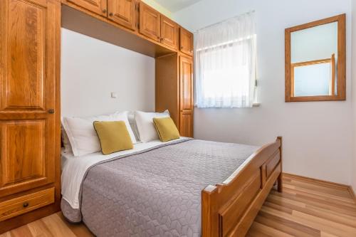 a bedroom with a large bed with yellow pillows at MBA modern beach apartments in Omiš