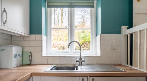 a kitchen with a sink and a window at Greenhowes in Rusland