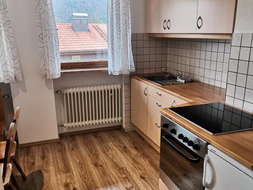 a kitchen with a sink and a stove top oven at Ferienwohnung Hochstaufen - Chiemgau Karte in Inzell