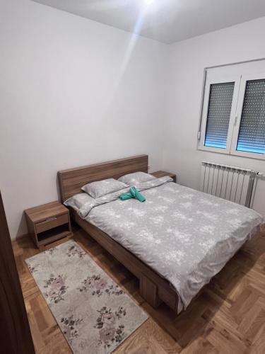 a bedroom with a bed with a green bow on it at Luxury House in Bijelo Polje