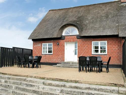 a group of chairs and a table in front of a building at Apartment Labarnas - 800m from the sea in Western Jutland by Interhome in Fanø