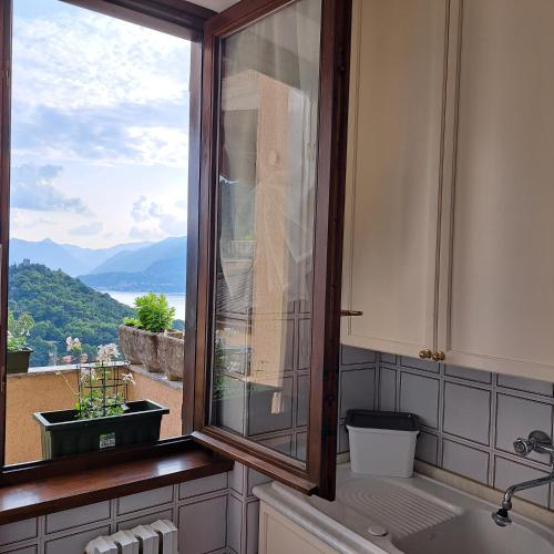 a kitchen with a window with a view of a mountain at La casa di Guia in Perledo