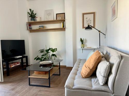 a living room with a couch and a table at Urban Retreat: 1-bedroom with terrace in Goudi in Athens