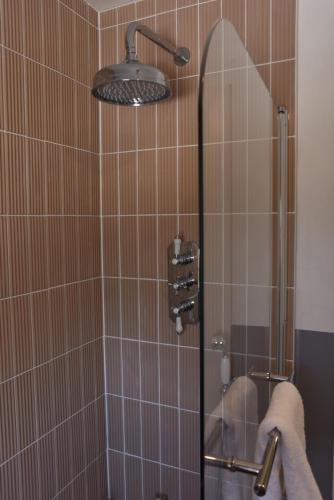 a shower with a glass door in a bathroom at Hillside House in Elgol