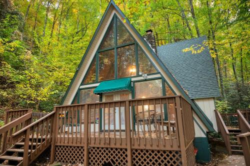 a cabin with a large window on a deck at Smoky Bear Hideaway in Gatlinburg