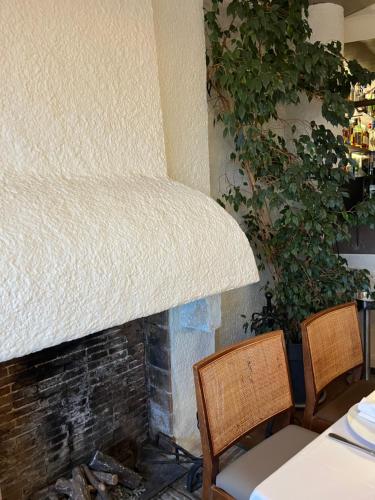 a couch sitting on top of a fireplace at Hostal de la Plaça - Hotel Boutique in Cabrils