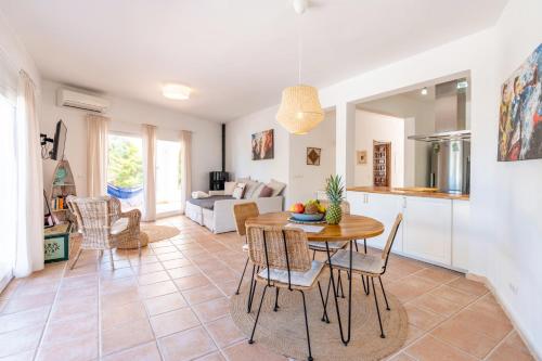 a kitchen and living room with a table and chairs at Sunset lover Cala Comte/ Cala Tarida/ Cala Bassa in Sant Josep de Sa Talaia