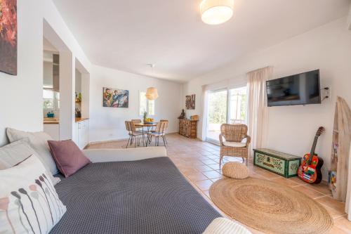 a living room with a couch and a table at Sunset lover Cala Comte/ Cala Tarida/ Cala Bassa in Sant Josep de Sa Talaia