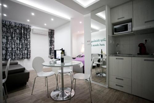 a kitchen and living room with a table and chairs at Apartment 4 You in Split in Split
