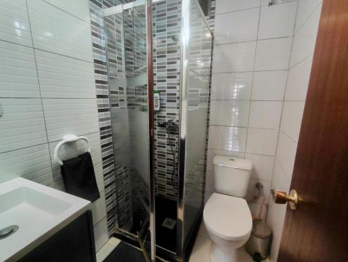 a bathroom with a toilet and a glass shower at Nice room-Terrace- Private toilete-Closer Sport Pier-Optical Fiber 1 GB in Las Palmas de Gran Canaria