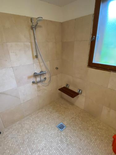 Łazienka z prysznicem i podłogą wyłożoną kafelkami w obiekcie NOUVEAU Villa Olga w mieście Jaujac