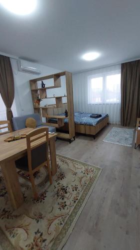 a room with a room with bunk beds and a table at White Apartments in Kosovo Polje