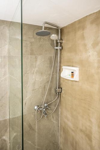 a shower in a bathroom with a glass door at Alexandra Apartments in Stalís