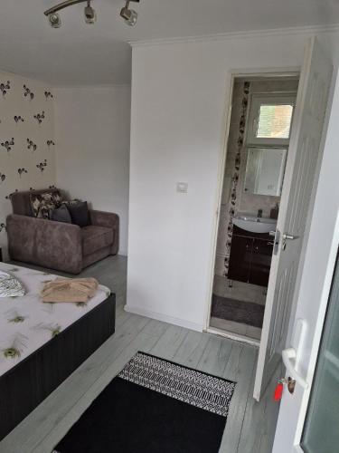 a bedroom with a bed and a couch in a room at Casa Elvina in Dubova