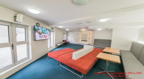 a living room with a couch and a table at Columbia Apartments in Auckland